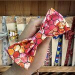 Dibujo de diadema para mascotas con estampado de panal en tonos naranjas y rosas, ideal para accesorios de animales.