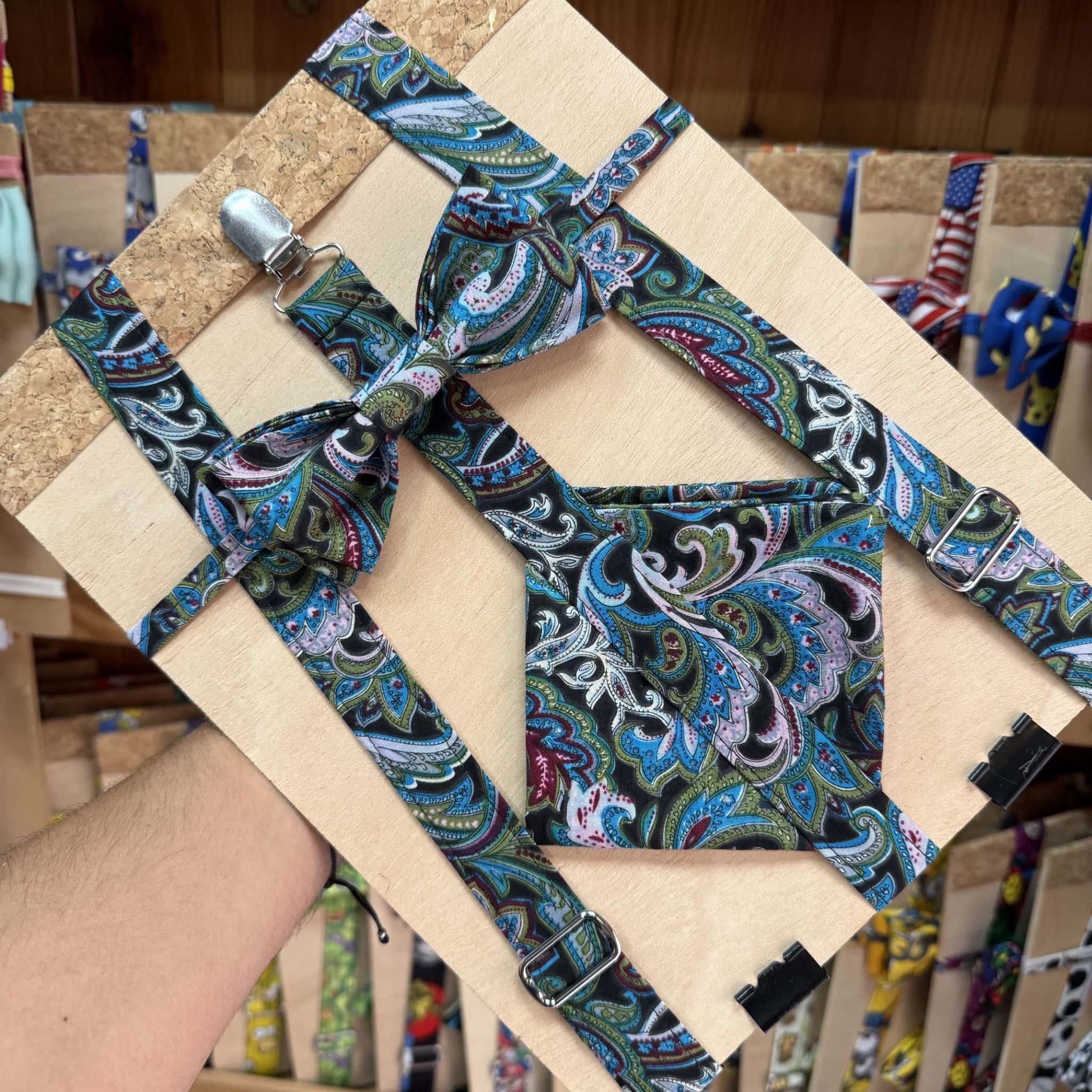 Elaborate tie and suspenders set with vibrant paisley pattern for men.