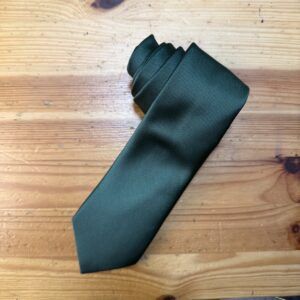 Lazo de corbata negro de seda con textura elegante en madera natural.