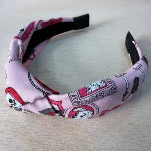 Tocado diadema con estampado de dibujos en tonos rosa y negro, accesorios de moda y complementos para mujer.